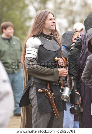 HARVEYSBURG, OH - OCTOBER 3: An unidentified man, wearing knight clothing, stands in the crowd watching a gaming joust at the Ohio Renaissance Festival in October 3, 2010.