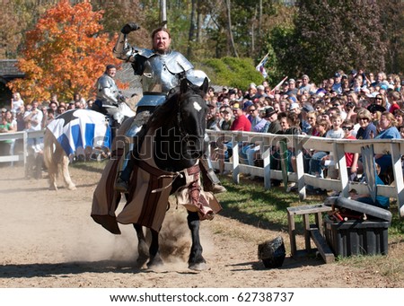 HARVEYSBURG, OH - OCTOBER 9: Reigning world champion Jouster Shane Adams rides in to joust while his contender, Sir Jason, looks on and smiles during the Ohio Renaissance Festival, October 9, 2010.