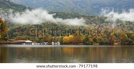 Fall colors of the trees reflecting in the water of a small lake in the mountains of North Carolina, USA.