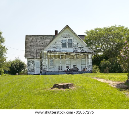 An old run down, weather beaten wood siding house that is in need of repair.  What a realtor would refer to as a fixer-upper.