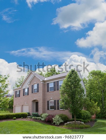 Two-Story Brick and Vinyl Siding House - Back yard of a two-story vinyl siding houses in the suburbs in America.