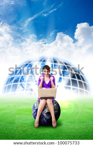 Beautiful woman hold notebook computer and digital world background on the grass field : Elements of this image furnished by NASA