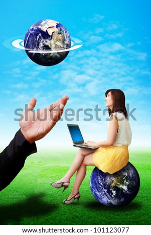 Business woman look at the tiny earth from god hand : Elements of this image furnished by NASA