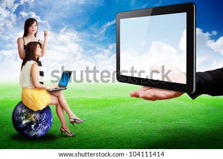 Two lady look at Tablet computer on the hand : Elements of this image furnished by NASA