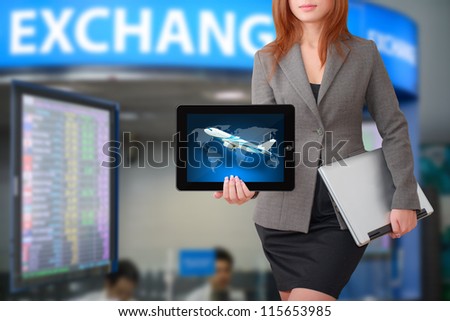 Business woman hold tablet with exchange rate board