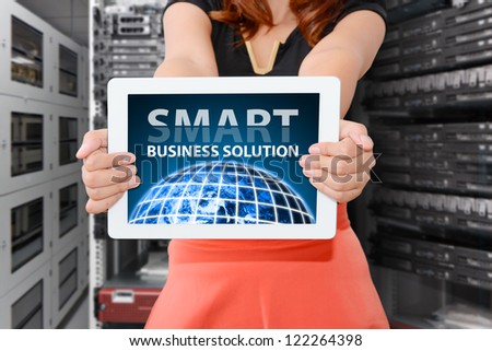 Tablet in data center room with smart solution : Elements of this image furnished by NASA