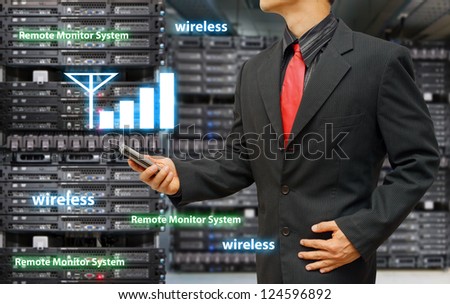 Programmer in data center room and mobile signal icon