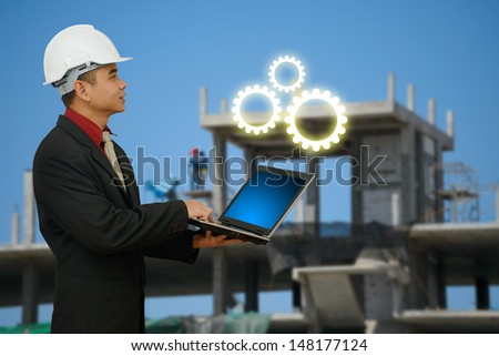 Engineering and laptop at construction yard