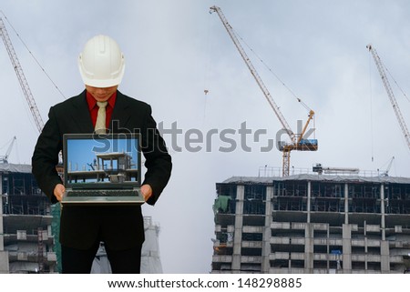 Engineering with laptop in construction yard