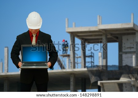 Engineering with laptop in construction yard