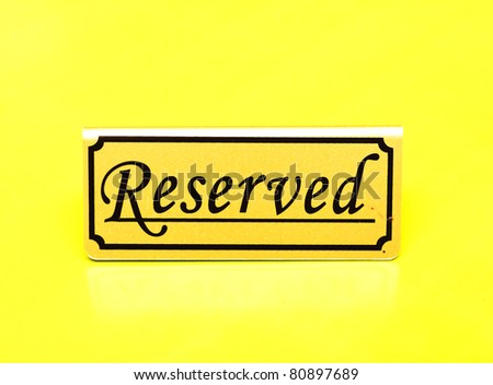 Reserved sign on yellow table