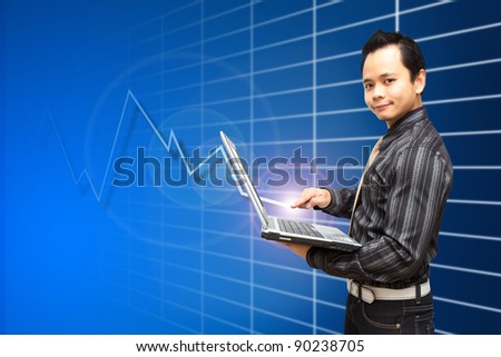 Smile Business man hold Note Book Computer with high graph