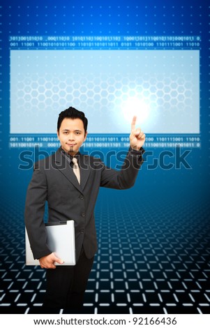 Business man hold notebook computer and point to LCD Monitor