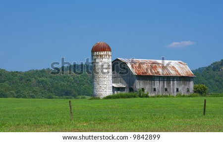 barn and silo in field
