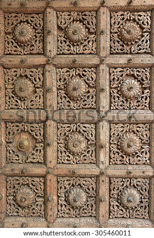 Nepali carved wood panel on a door