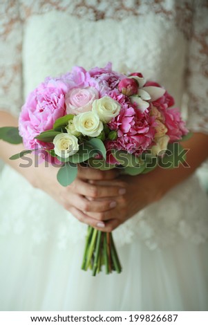 delicate purple wedding flowers in hands of the bride bright colors