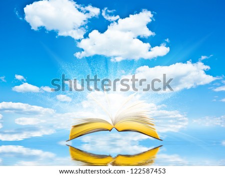 Open book blue sky and reflection. Magic book background