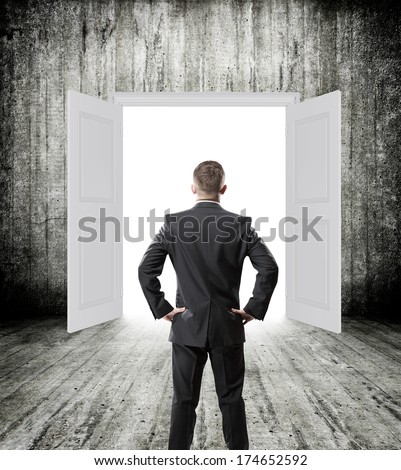 Conceptual image of white opened door with businessman. Perspective. Future