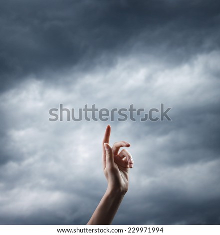 religion concept. finger touching the magic sky