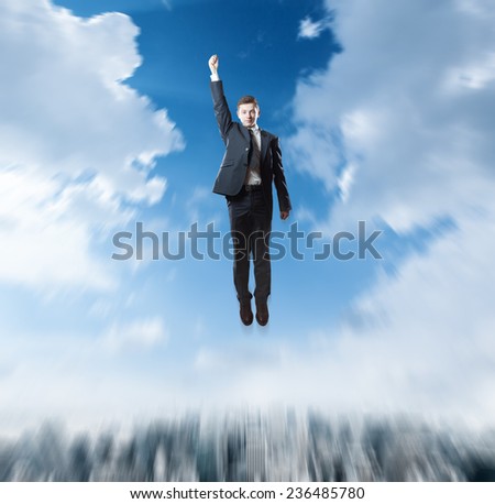superhero businessman flying over the city