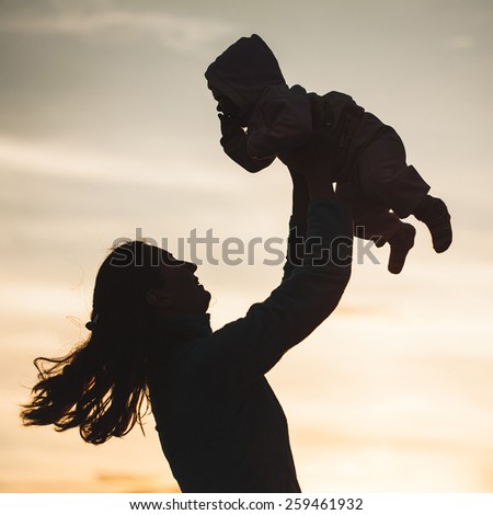 silhouette of happy family mother and child