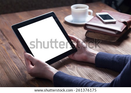 woman shows screen of digital tablet in her hands