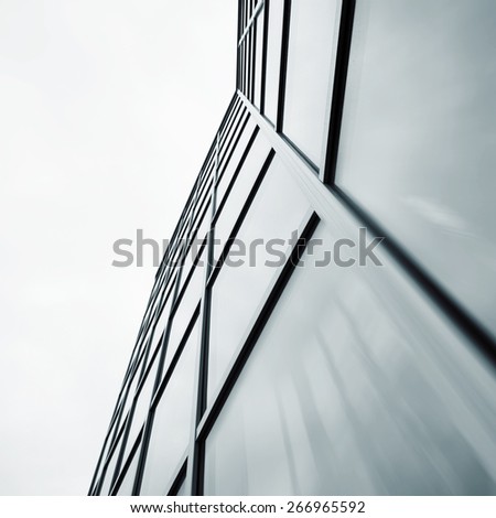 Wide angle abstract background view of steel light blue high rise commercial building skyscraper made of glass exterior. concept of successful industrial architecture and office center building