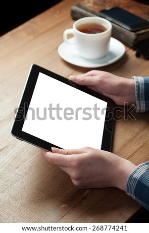 woman shows screen of digital tablet in his hands.