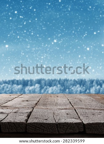 Blue Christmas background with trees and snow with wooden floor