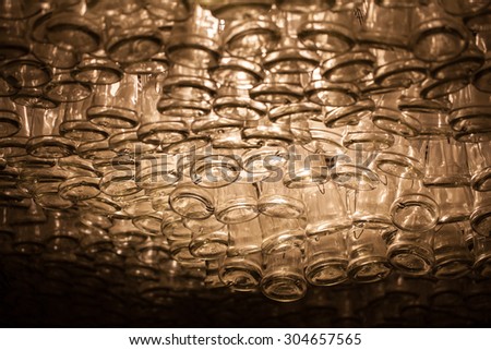 empty wine bottles hanging from a ceiling