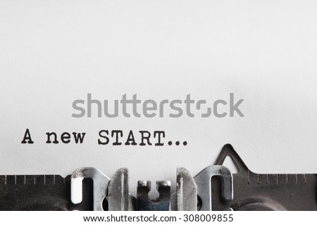 New start slogan written by a typewriter on a sheet of a paper