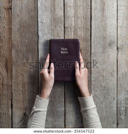 christian woman holding the bible. top angle of view