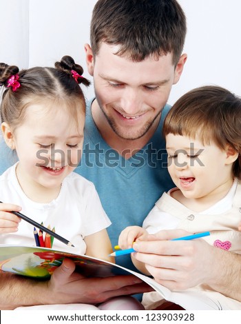 two cute little girls with their dad paint crayons