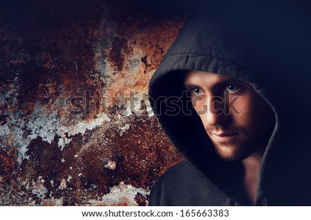 Portrait of a young angry man in the hood
