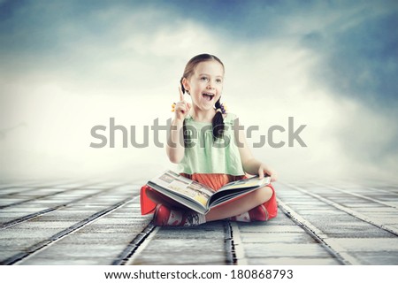 Small cute child reading a book