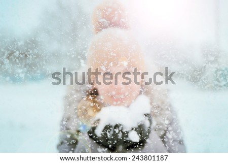 Happy young woman having fun in the snow
