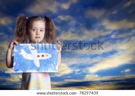 The child with the drawn plane against the sky