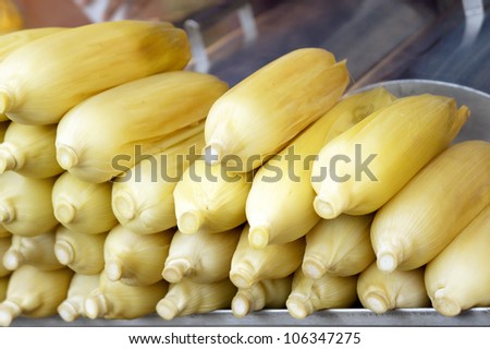 Fresh and sweet boiled Japanese corn cob on display rack at the market.