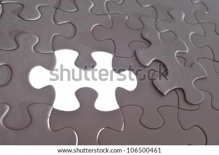 Missing jigsaw puzzle piece with light glow, business concept for completing the final puzzle piece.