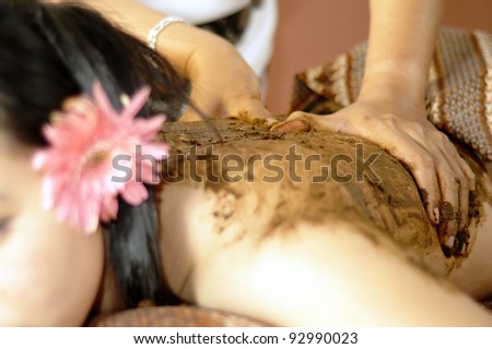 Body scrubbing using traditional herbs and spices in shallow depth of field