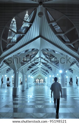 Interior of the As-Syakirin mosque, famous landmark in Kuala Lumpur, Malaysia in its ambient blue light.
