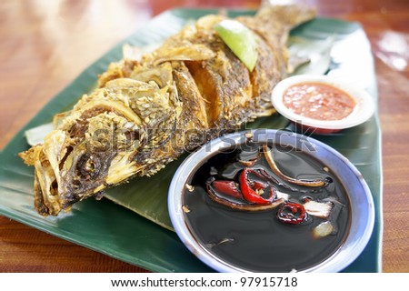 Hot grilled fish, blend in spices and layered in banana leaf (shallow depth of field)