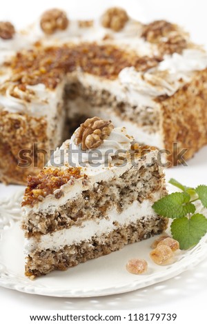Piece of cake with nuts and caramel  on cake background
