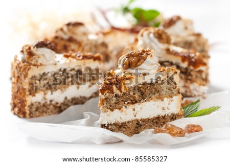 Piece of cake with nuts and caramel  on white background