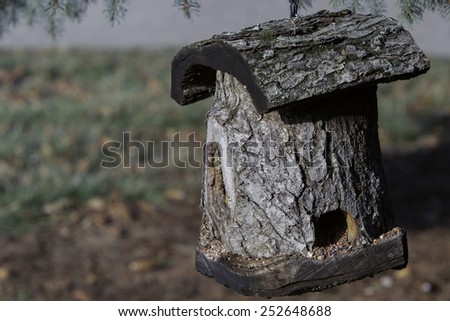 Bird house made out of a tree log, with unique style. hand crafted bird house.
