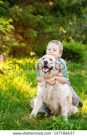 Little Boy With A Golden Retriever Outdoor