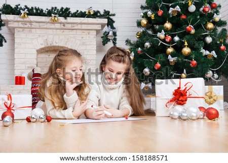 Two little girls writes letter to Santa
