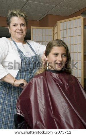 young girl getting her hair done at the salon