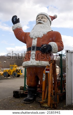 12 foot statue of Santa greeting customers at the local dump