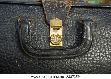 Vintage leather doctor bag showing the brass clasp and worn leather handle,used in making house calls